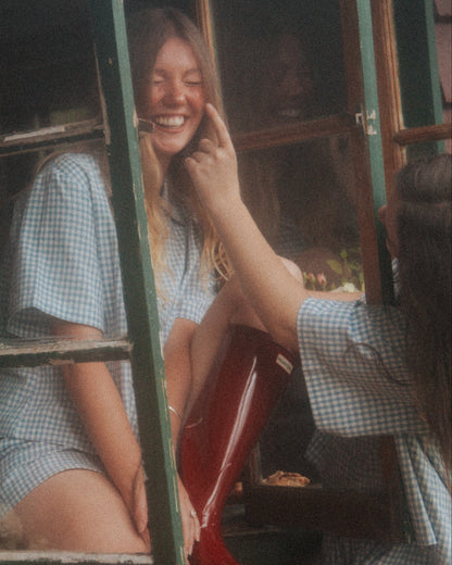 Woman Wearing the Blue Wren gingham pyjama set by Simply Provincial, handmade from 85 percent cotton and 15 percent linen. Inspired by the delicate Australian Blue Wren bird and crafted for comfort and timeless slow-fashion style. 